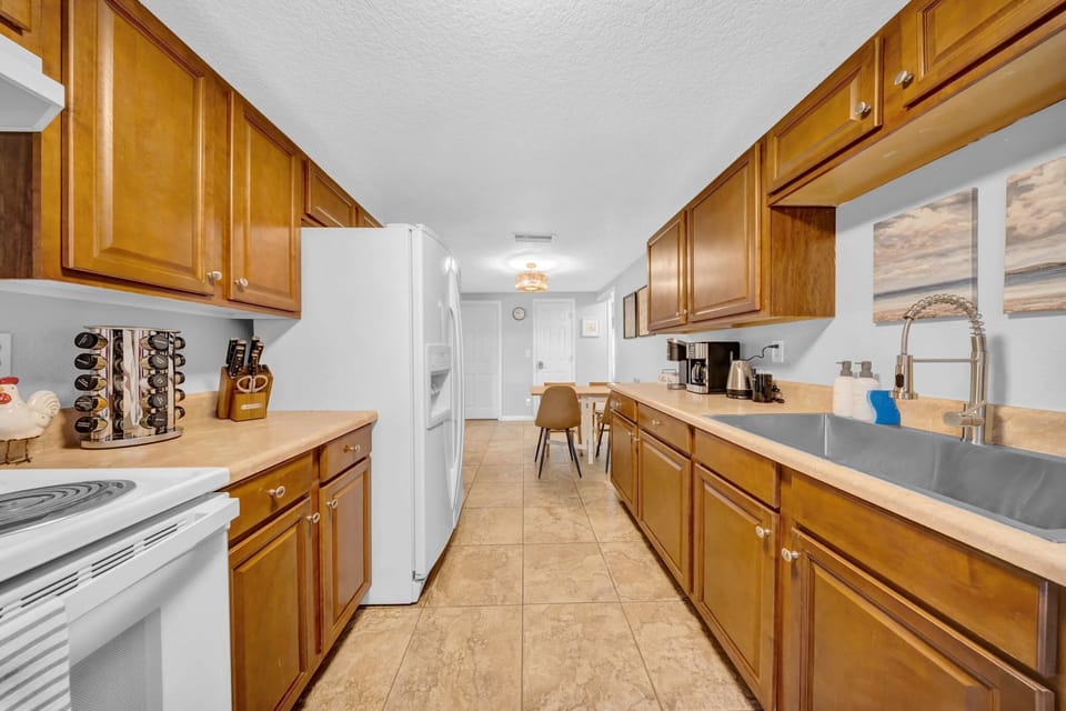 Fully equipped kitchen with a full-size fridge, oven, microwave, toaster, air fryer, blender, and charming farmhouse sink—everything you need to create delicious meals