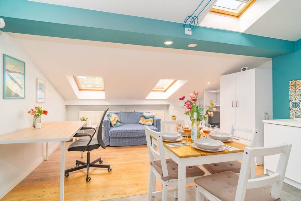 Bright Living and Dining Area – Cozy Sofa, Working Desk, and Dining Space Under Skylights | Book Now with RENTUJEMY.COM