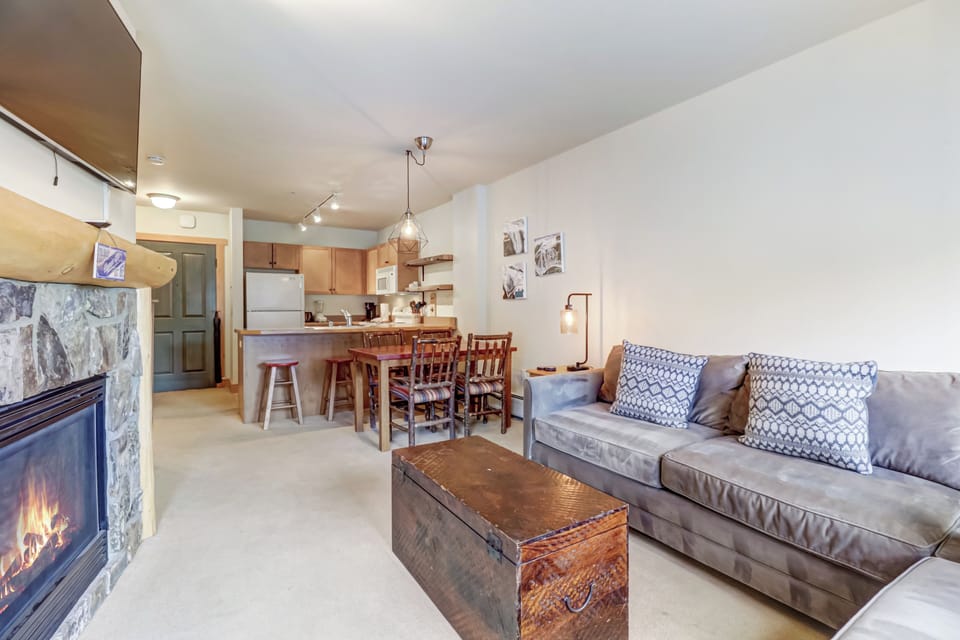 Cozy living room with open-concept kitchen.