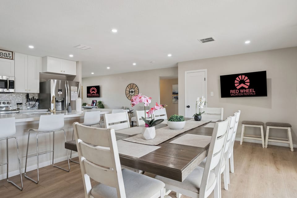Stylish open kitchen with island seating, coffee maker, and full cookware.