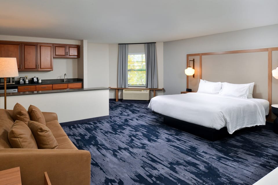 Premium bedding, desk, laptop workspace, blackout drapes