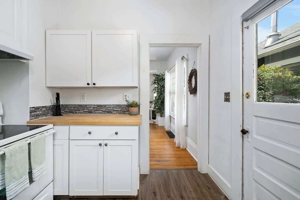 Kitchen with sink and back door access.