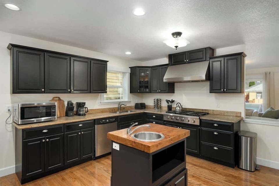 Kitchen with dark cabinetry and prep space.