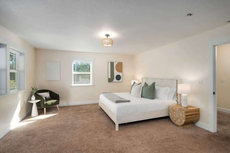 Bedroom 1 with king bed and sitting chair.