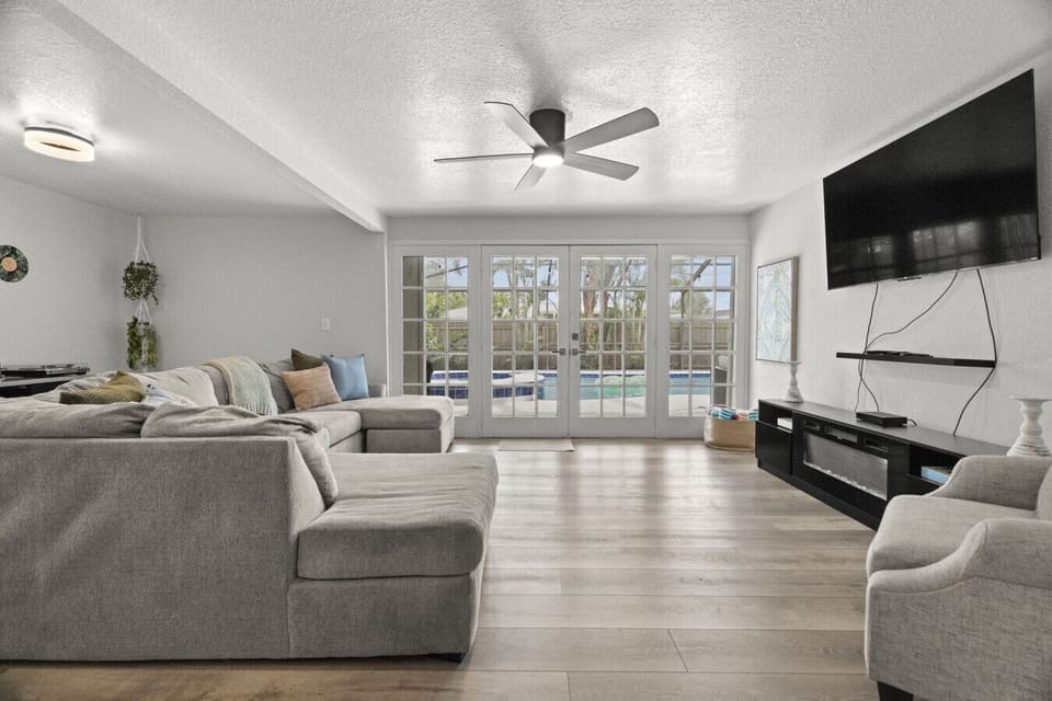 This open-concept living area flows seamlessly from the cozy living room to the lanai, creating the perfect space for relaxing or enjoying the Florida sunshine