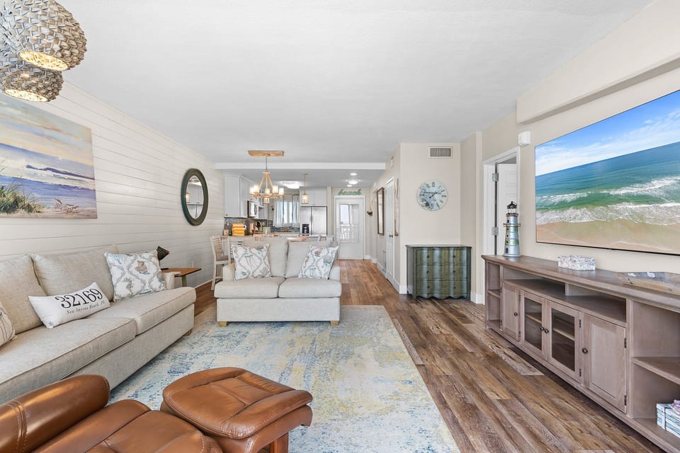 Spacious beachside condo with open living, dining, and kitchen areas. Enjoy coastal décor, modern comforts, and a relaxing seaside atmosphere perfect for your next oceanfront getaway.