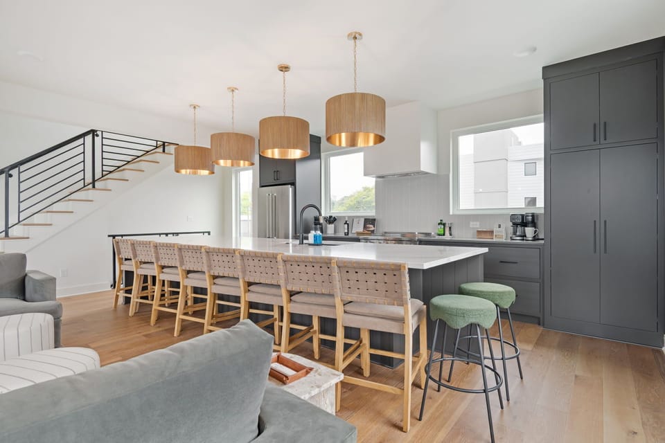 Fully equipped kitchen with generous bar seating and an open dining layout.