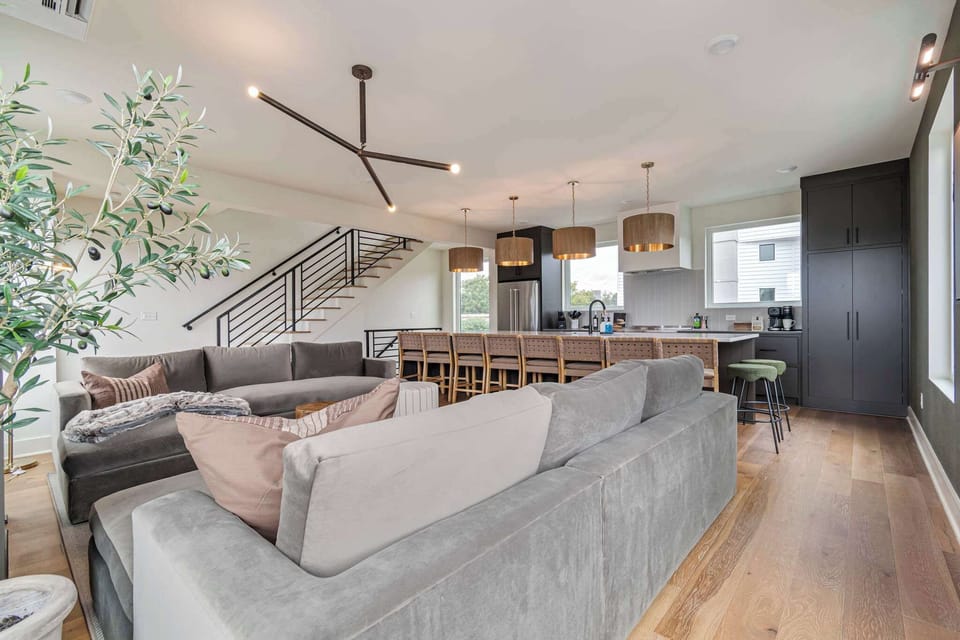 Comfortable living room with plush sectional seating and seamless flow into the kitchen.