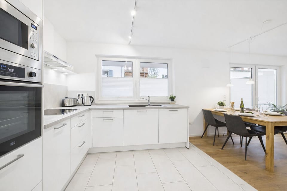 Fully equipped, modern kitchen with an oven, microwave, and dishwasher.