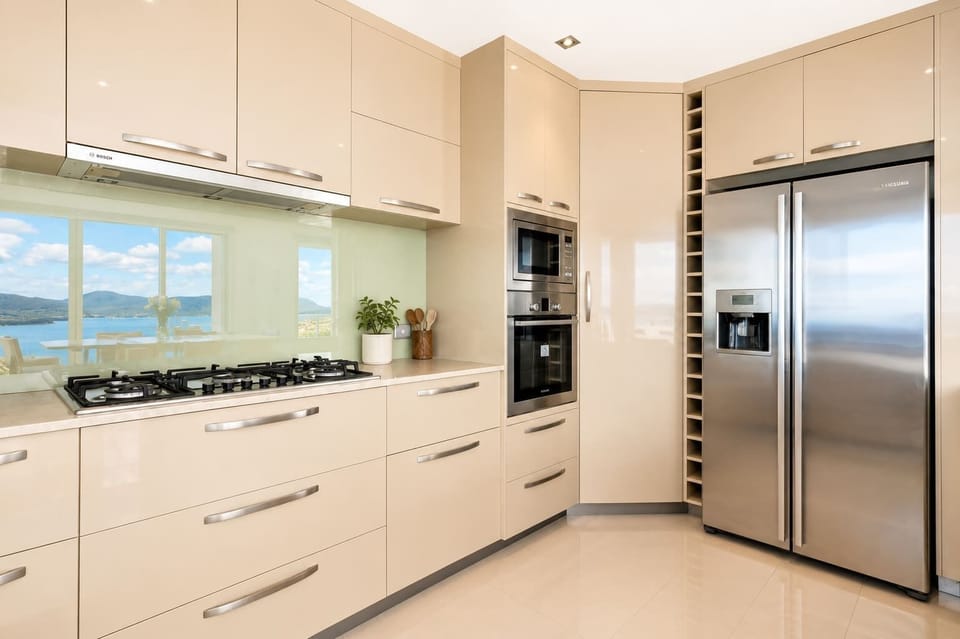 Well-equipped kitchen featuring gas cooking, oven, microwave and a large fridge/freezer.