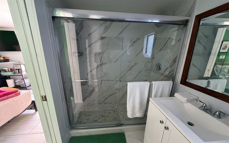 Clean, modern bathroom with walk-in shower and fresh linens.
