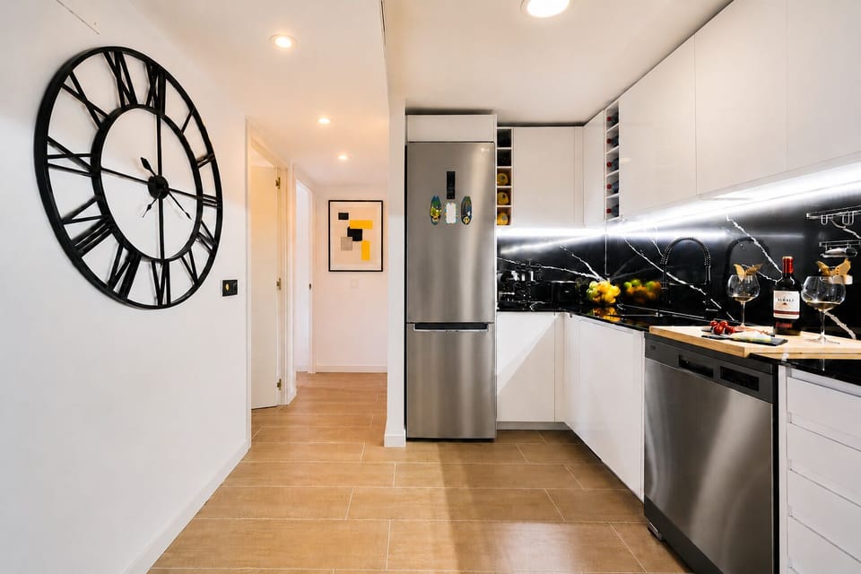 Modern, fully equipped kitchen with high-end appliances, elegant black quartz backsplash, and everything you need for a comfortable stay.