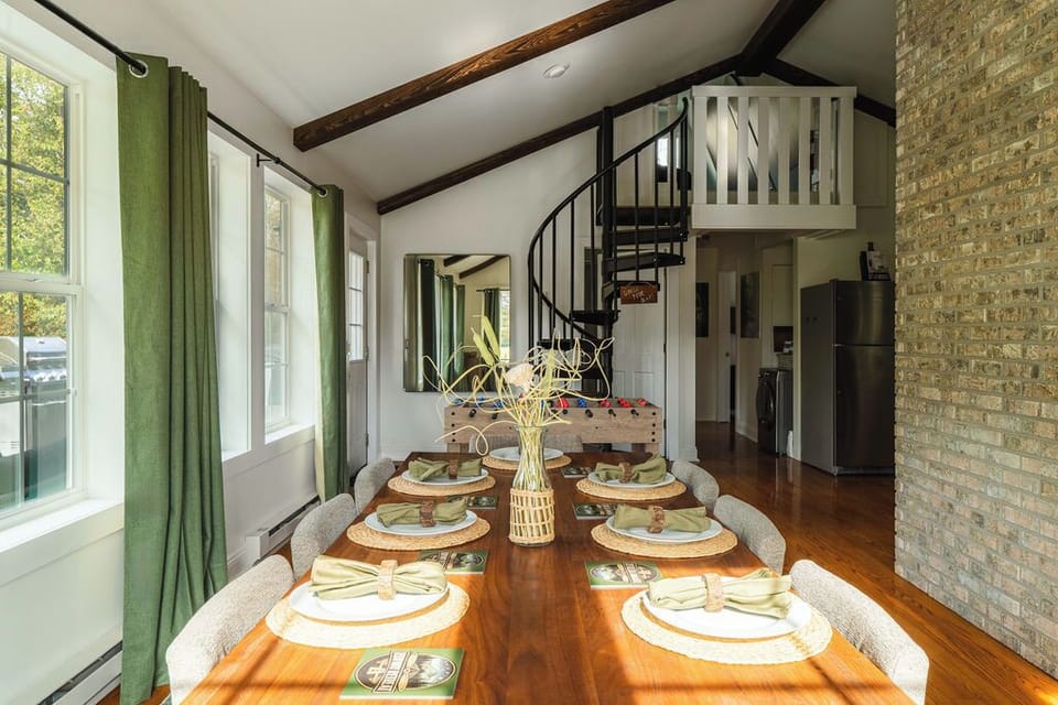 Enjoy meals, games, or planning adventures in this open-concept space featuring a unique spiral staircase leading to the loft.