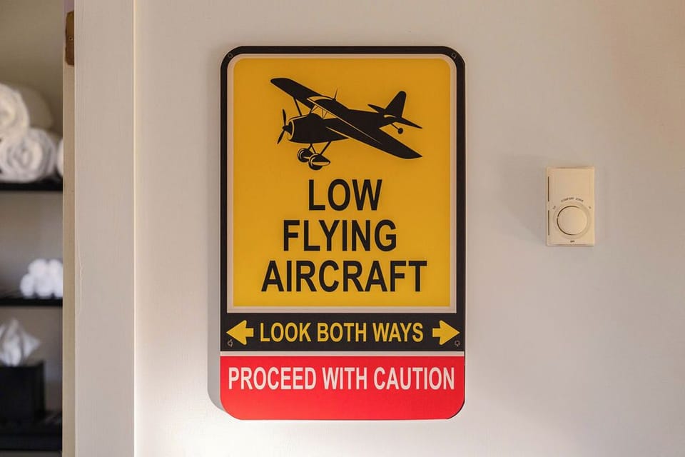 Fun, quirky details bring the aviation theme to life—like this cheeky sign in the hallway. Expect the unexpected at Runway Retreat!
