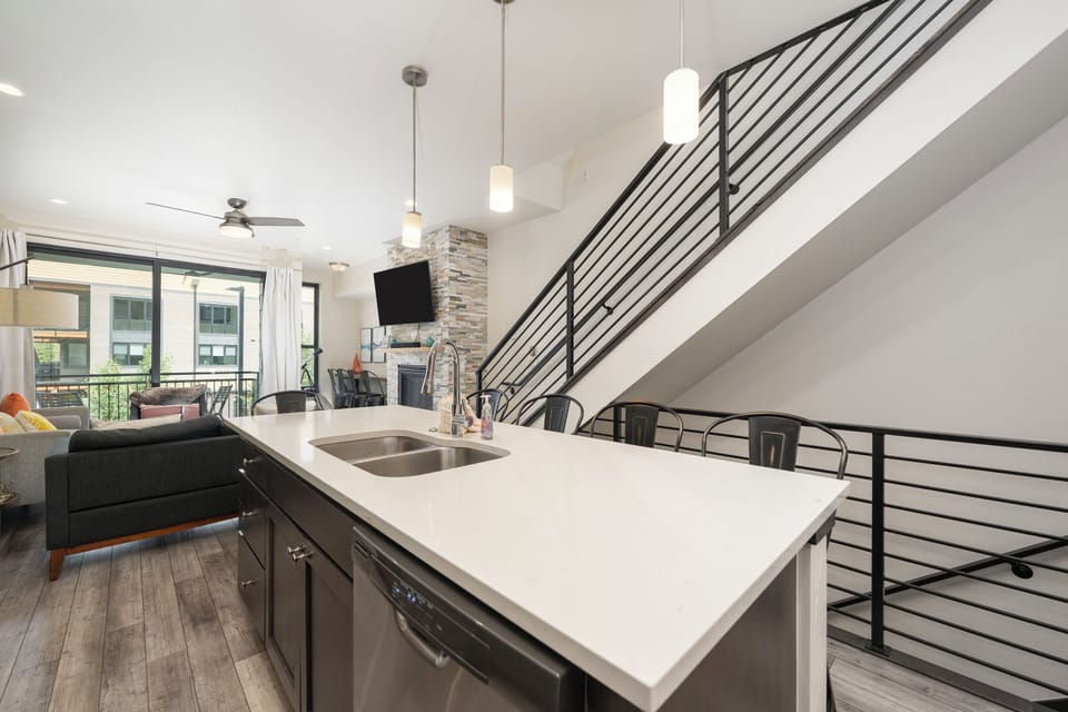 Your modern loft features sleek kitchen island with city views, perfect for cooking and entertaining in style.