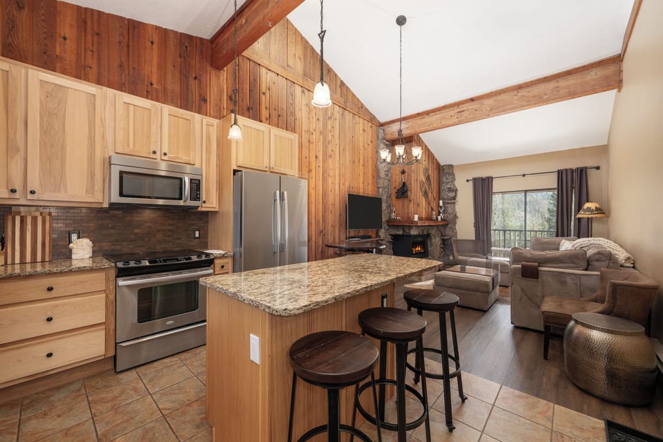 Cozy up in your mountain-style retreat with full kitchen, warm fireplace, and rustic wood details creating the perfect alpine getaway.