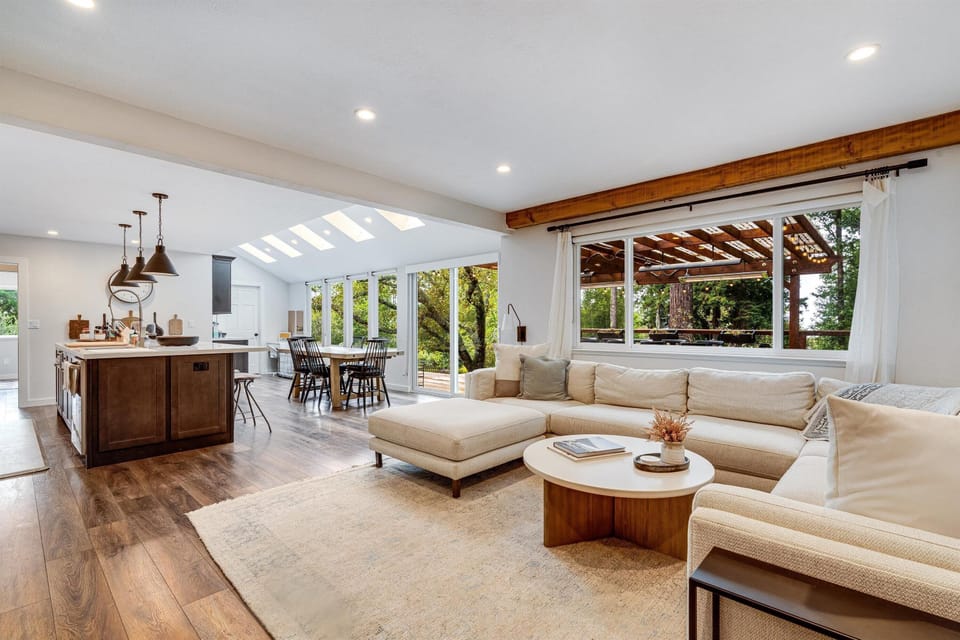 Sunlit living room with cozy seating and garden views