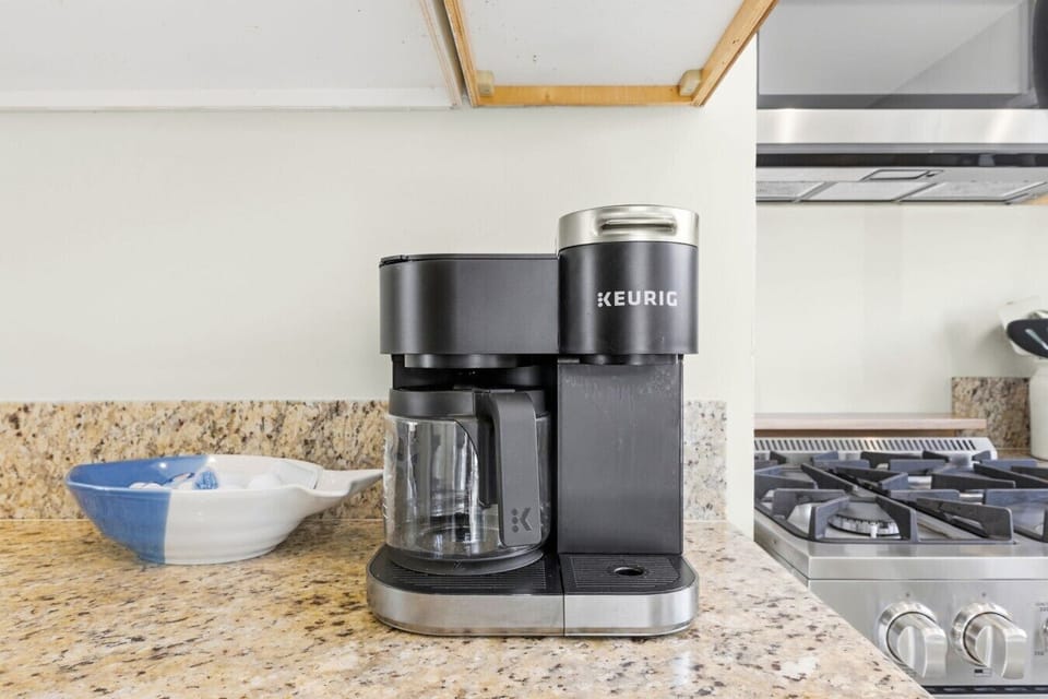 Fully equipped coffee bar complete with a modern Keurig duo coffee maker and granite counter space.