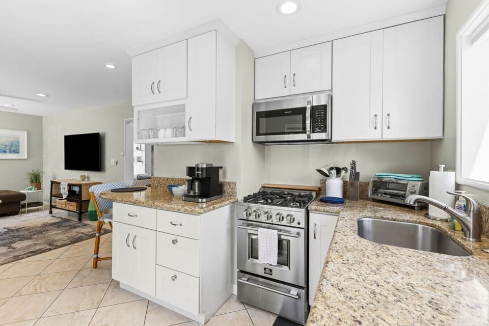 Fully equipped kitchen with updated appliances, ample counter space, and a drip coffee maker—perfect for cooking and morning brews