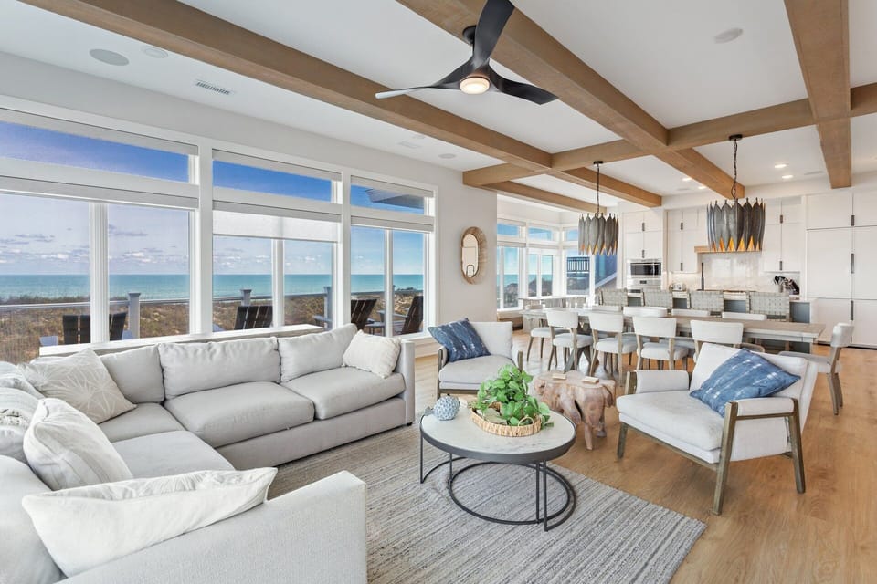 Take in panoramic ocean views from the spacious living area featuring plush seating, a flat-screen TV, and a cozy gas fireplace.