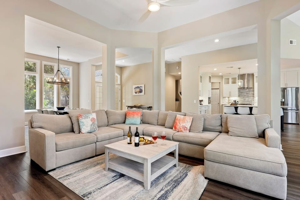 The inviting living area is anchored by a large, plush sectional sofa, providing ample seating for the whole family to gather for a movie night or board games.