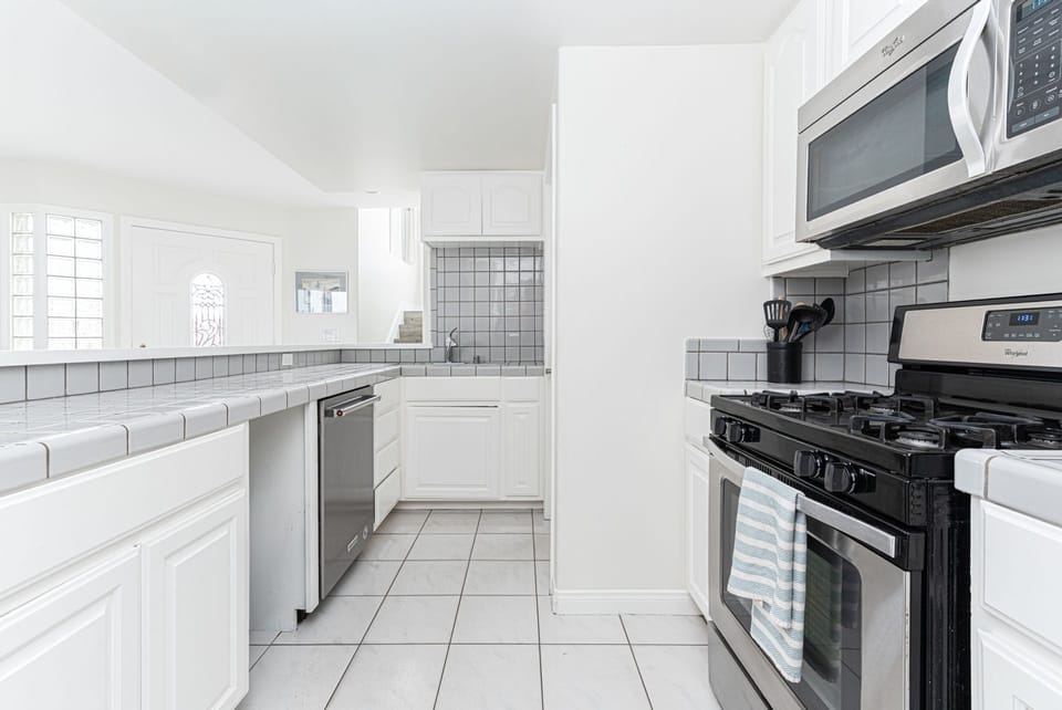 Fully equipped ground floor kitchen with sleek stainless steel appliances
                