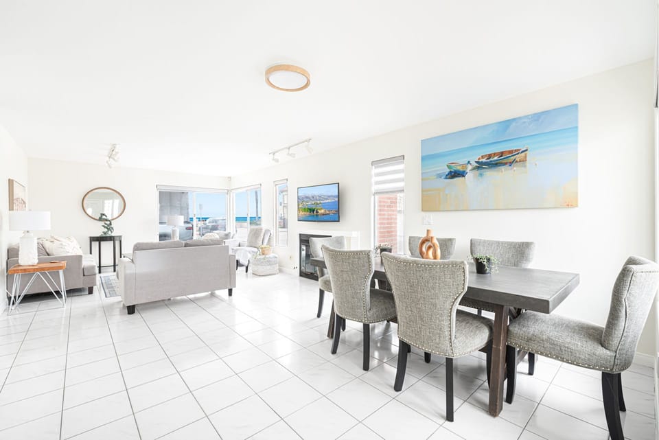 Open-concept living and dining areas on the ground floor showcase ocean views
                