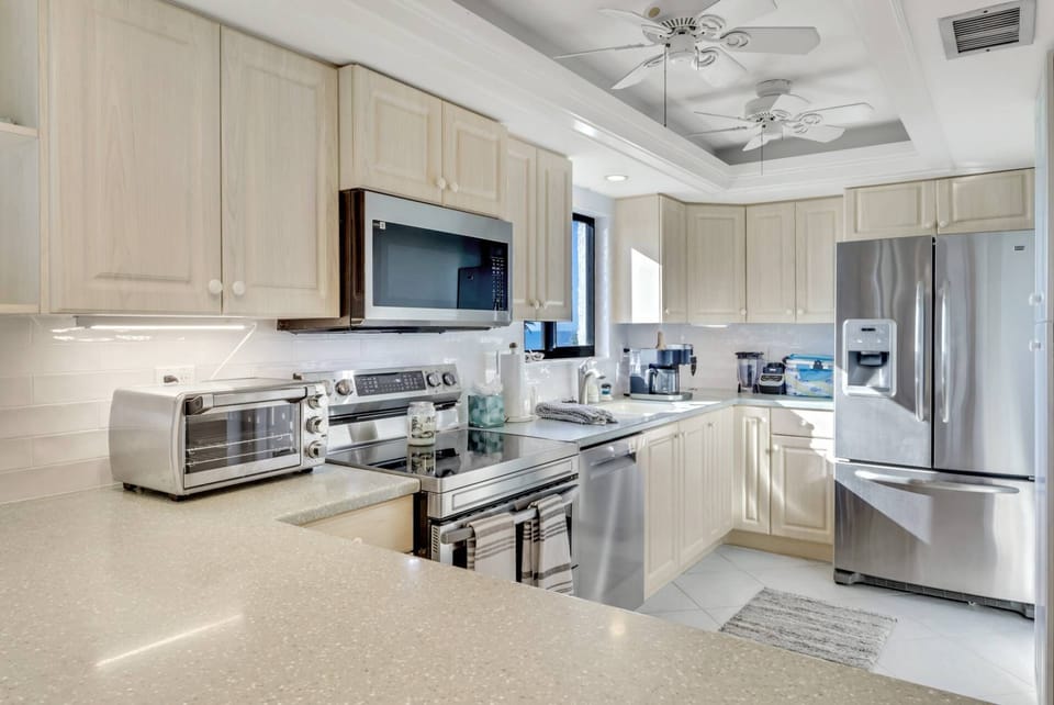 The kitchen is well equipped with a smooth-top double oven, dishwasher, refrigerator/freezer and microwave.
