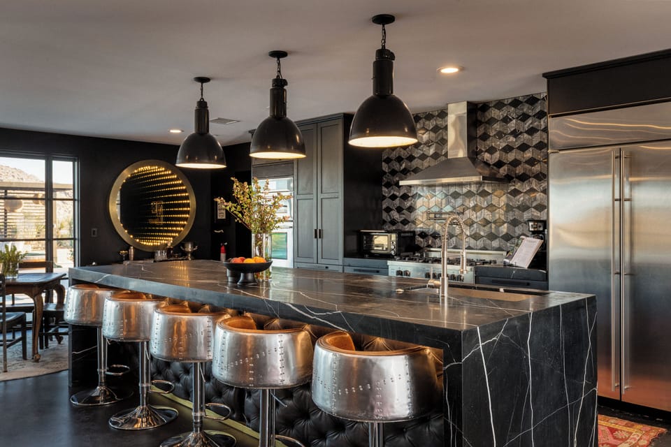 Chef's kitchen with stainless steel appliances, and 12' marble island with seating for 5.