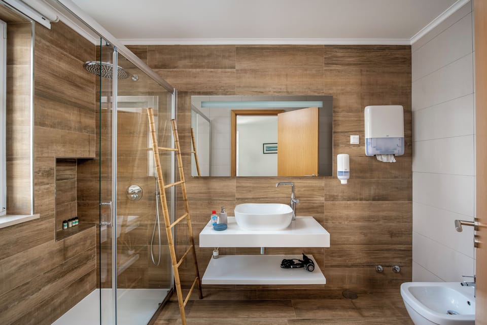 Bathroom | Shower, rainfall showerhead, hair dryer, bathrobes