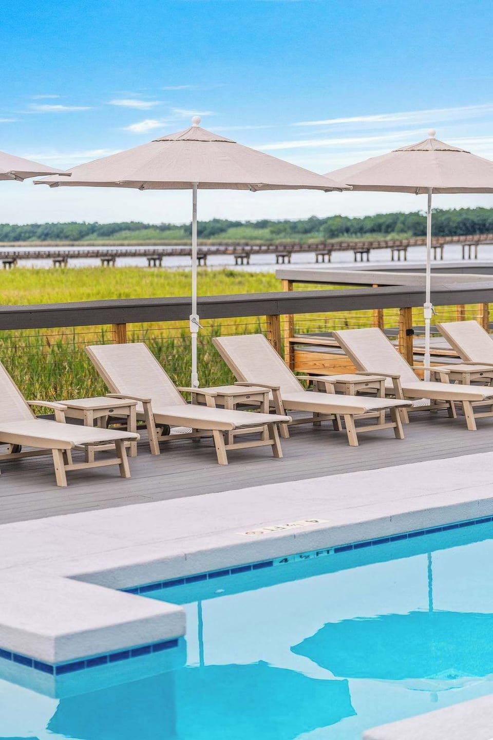Lounge by the sparkling pool, sip cocktails from the poolside bar, and soak up the laid-back elegance of Winyah Bay Club