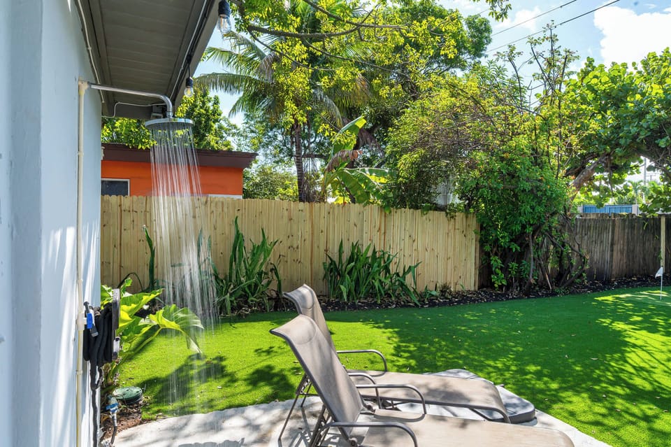 Outdoor shower beside the lawn.