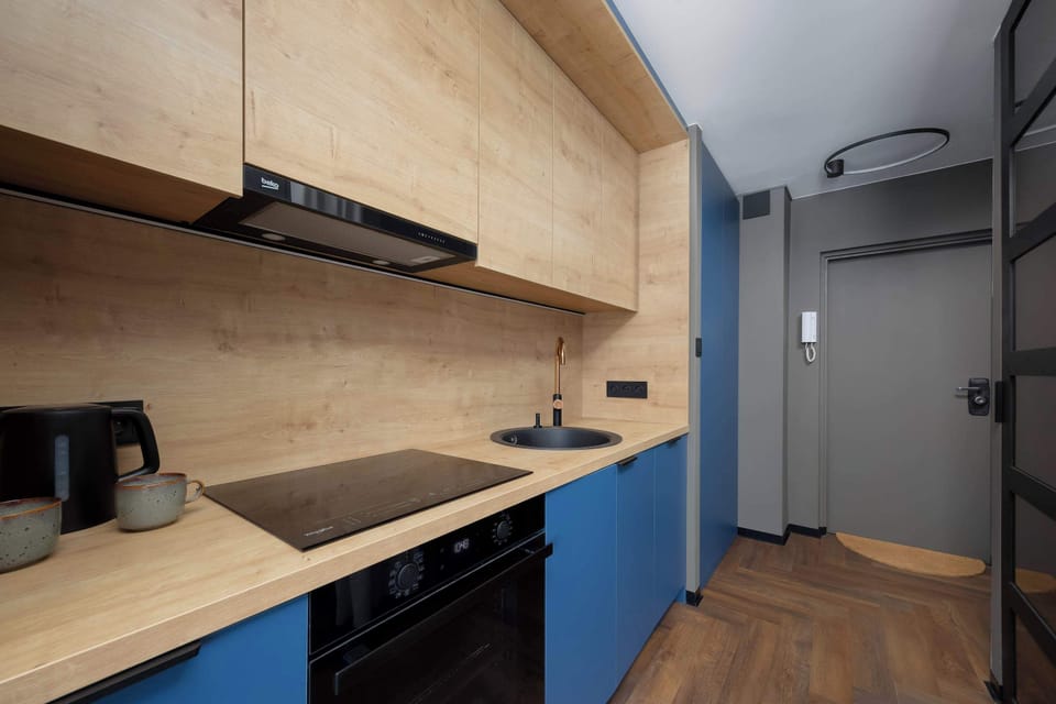 The modern kitchenette with an oven and coffee maker combines functionality with elegant design.