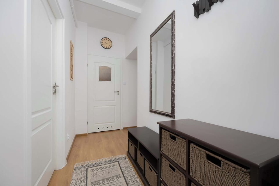 A view of the hallway from another angle shows the harmonious blend of white and wood that gives the interior a sense of spaciousness.