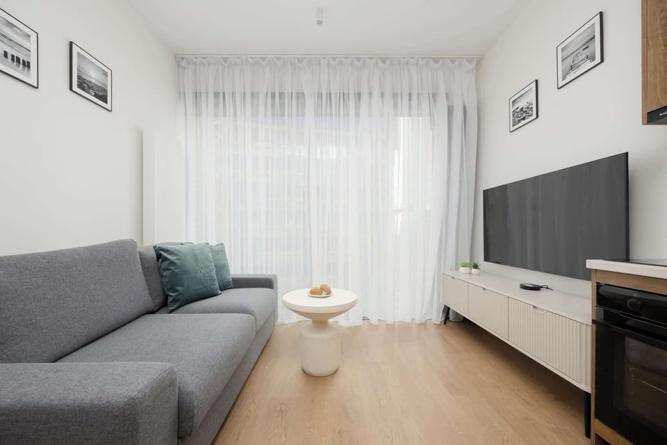 A lounge with a comfortable sofa and television, ideal for relaxing and unwinding after a day of sightseeing. 