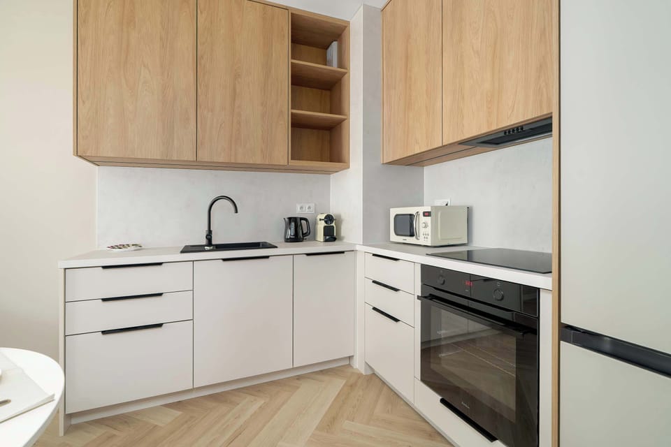 The sleek design of the kitchenette blending seamlessly with the living area.