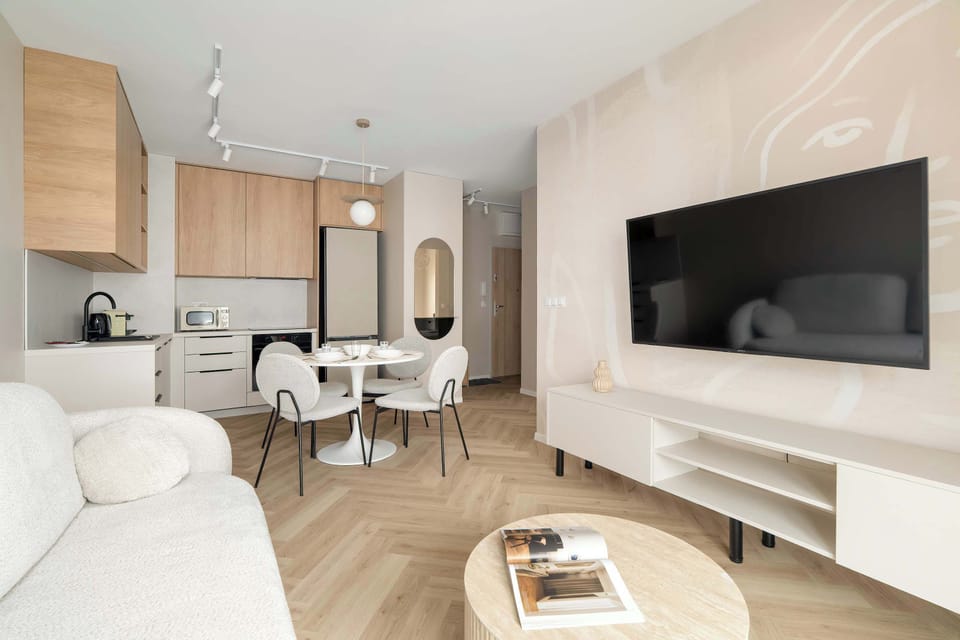 The elegant living room featuring a double sofa bed, perfect for relaxing or sleeping.