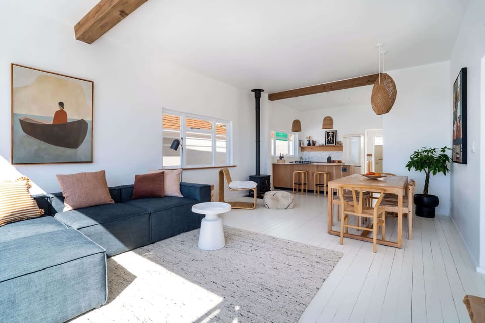 An open plan living, dining and kitchen area with a wood burning fireplace is the perfect place to rest on a cold winters day. 