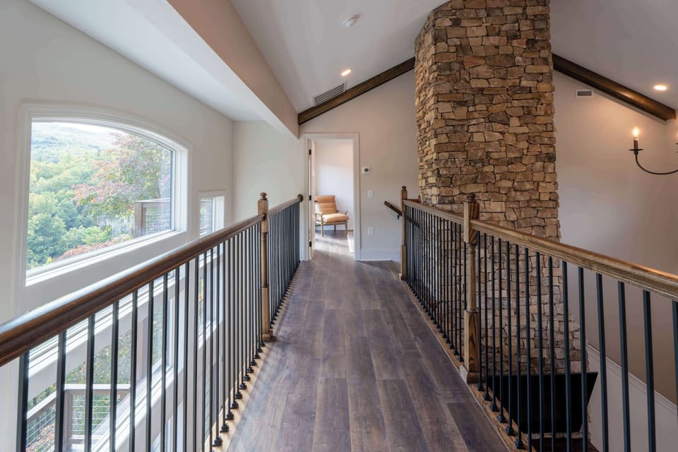 Open-Concept Upstairs Over Main Floor Living Room & Kitchen. Connects staircase and both upstairs bedrooms.