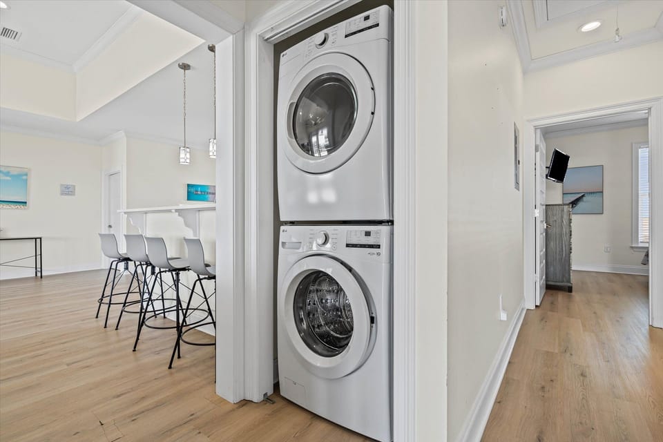 Your laundry stays fresh with this convenient in-unit washer and dryer, tucked neatly into your modern coastal retreat.