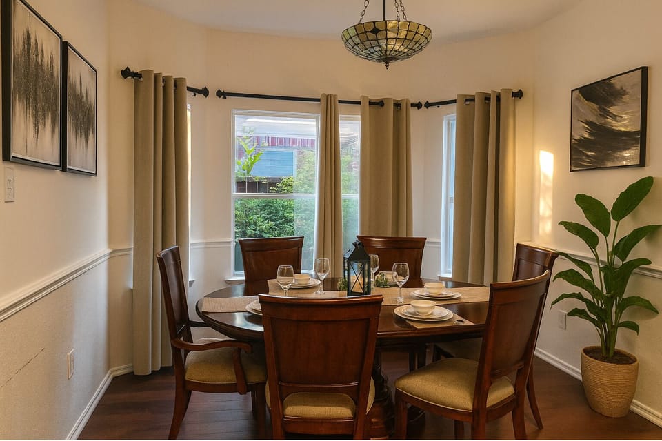 This warm and welcoming dining area features a graceful oval table with six cozy chairs, offering the perfect space to share meals, celebrate moments, and enjoy heartfelt conversations.