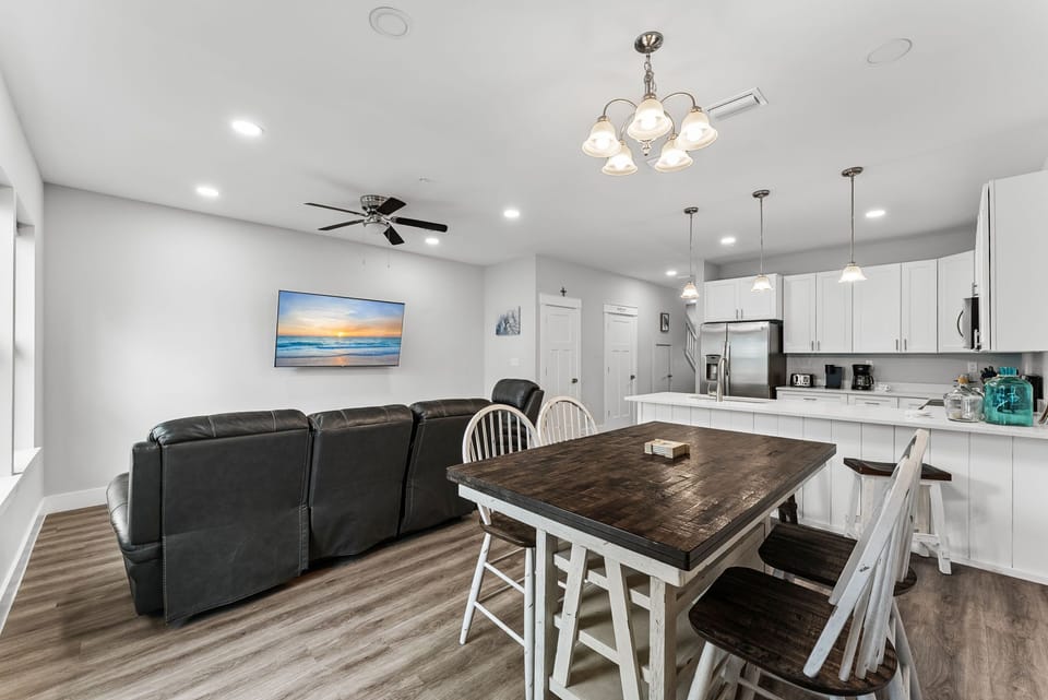 Open-concept living and dining area with modern kitchen and comfortable seating.