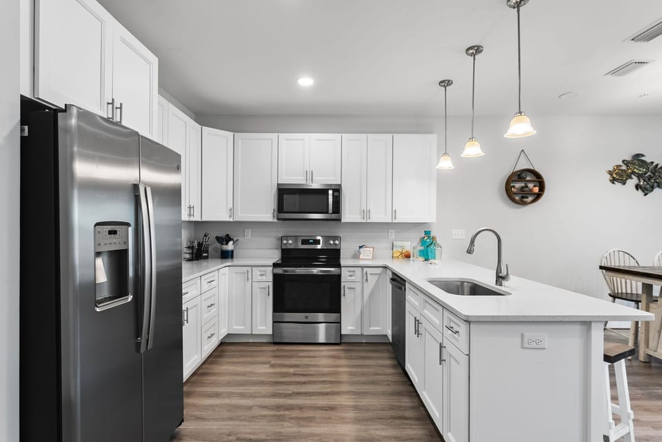 Modern kitchen with stainless steel appliances and white cabinetry