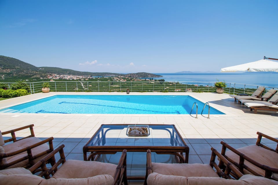 Veranda sitting area and swimming pool with view