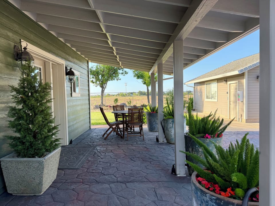 Guesthouse front porch area with a table for two.