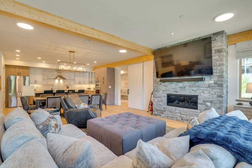 Generous seating around fireplace and 85 inch screen