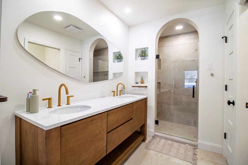En suite full bathroom includes large shower, double vanity, and charming details 