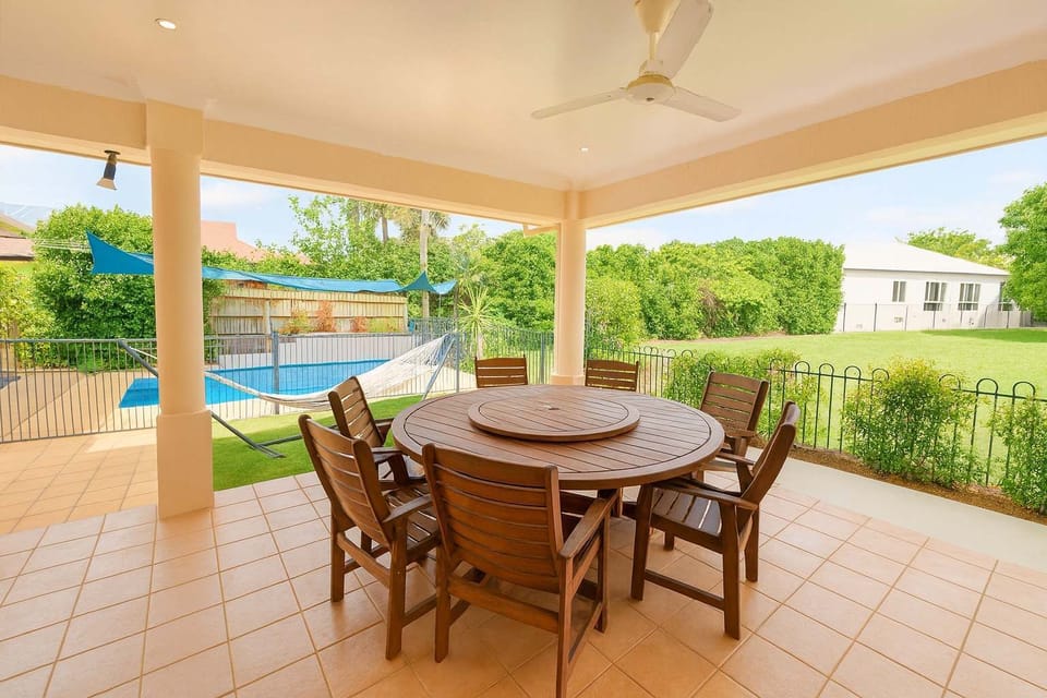 Outdoor Entertaining Area – Enjoy alfresco dining by the pool in this spacious covered patio