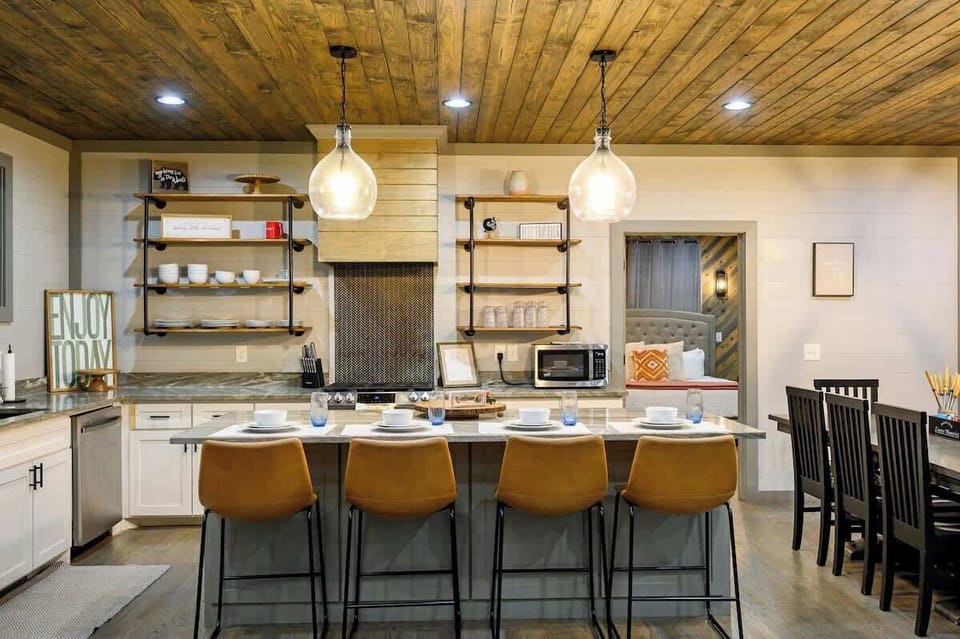 Fully Equipped & Modern! This stylish kitchen at Pining for Pinot features open shelving, a spacious island, and everything you need to cook, gather, and enjoy time together.