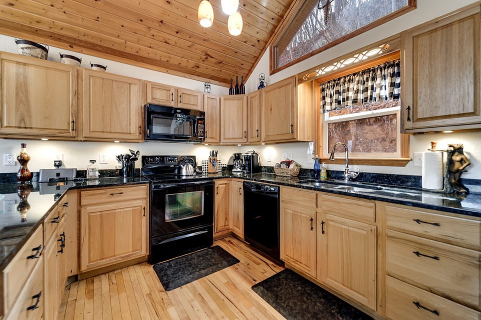 Spacious kitchen and dining area with vaulted ceilings and natural light at Dream Weaver cabin near Nantahala.